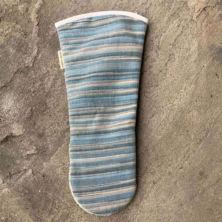 Blue striped long oven mitt gauntlet style flat with grey background showing the back of the glove