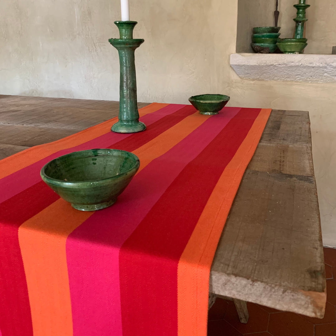 table runner red orange pink on wooden table with green bowls and candle sticks