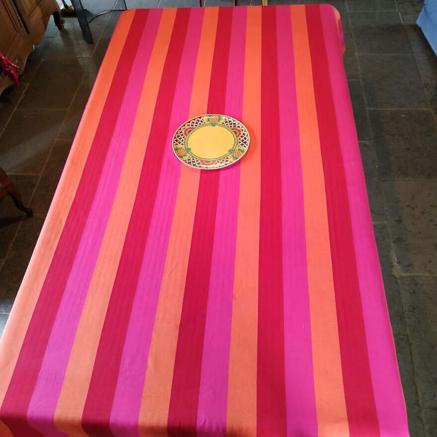 Tablecloth red orange pink stripes on a long rectangle table from above