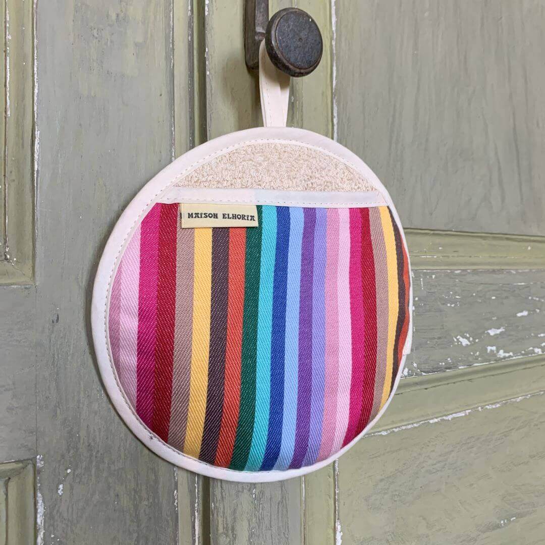 Pot holder rainbow hanging off the wooden old fashion wooden door 