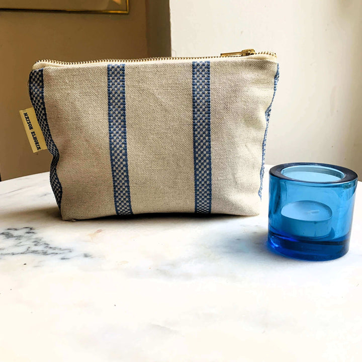 Toiletry bag for men linen union with blue stripes And a blue candle