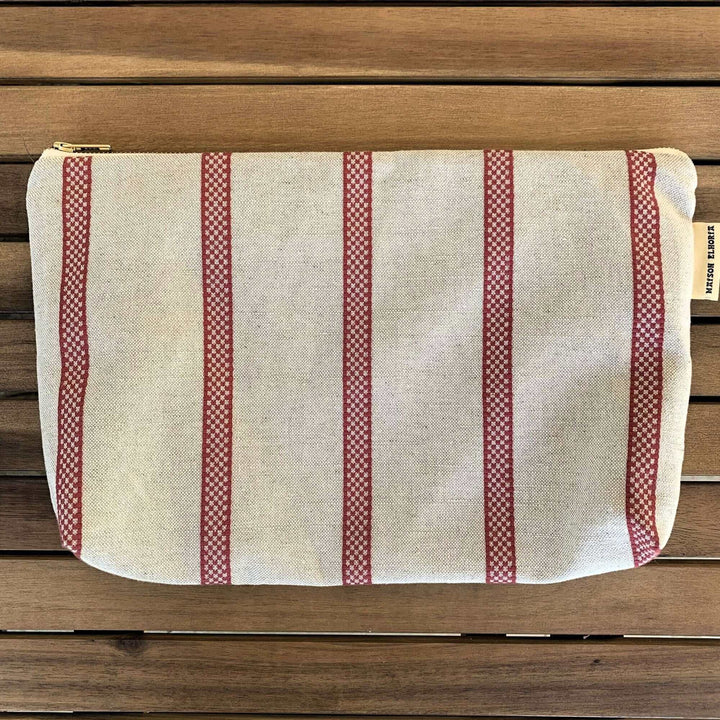 Make up bag linen with old fashion French Style red stripes on a garden table close up