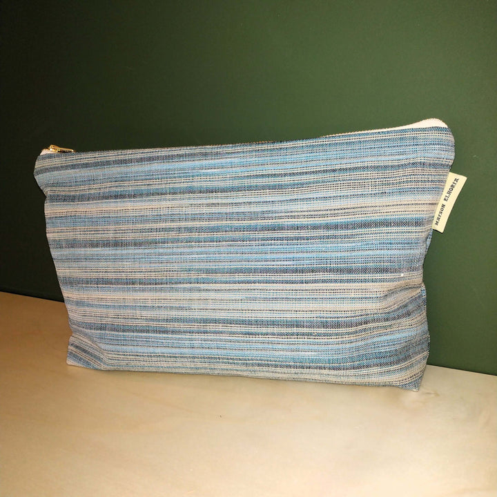 Blue striped men toiletry bag on a kitchen worktop