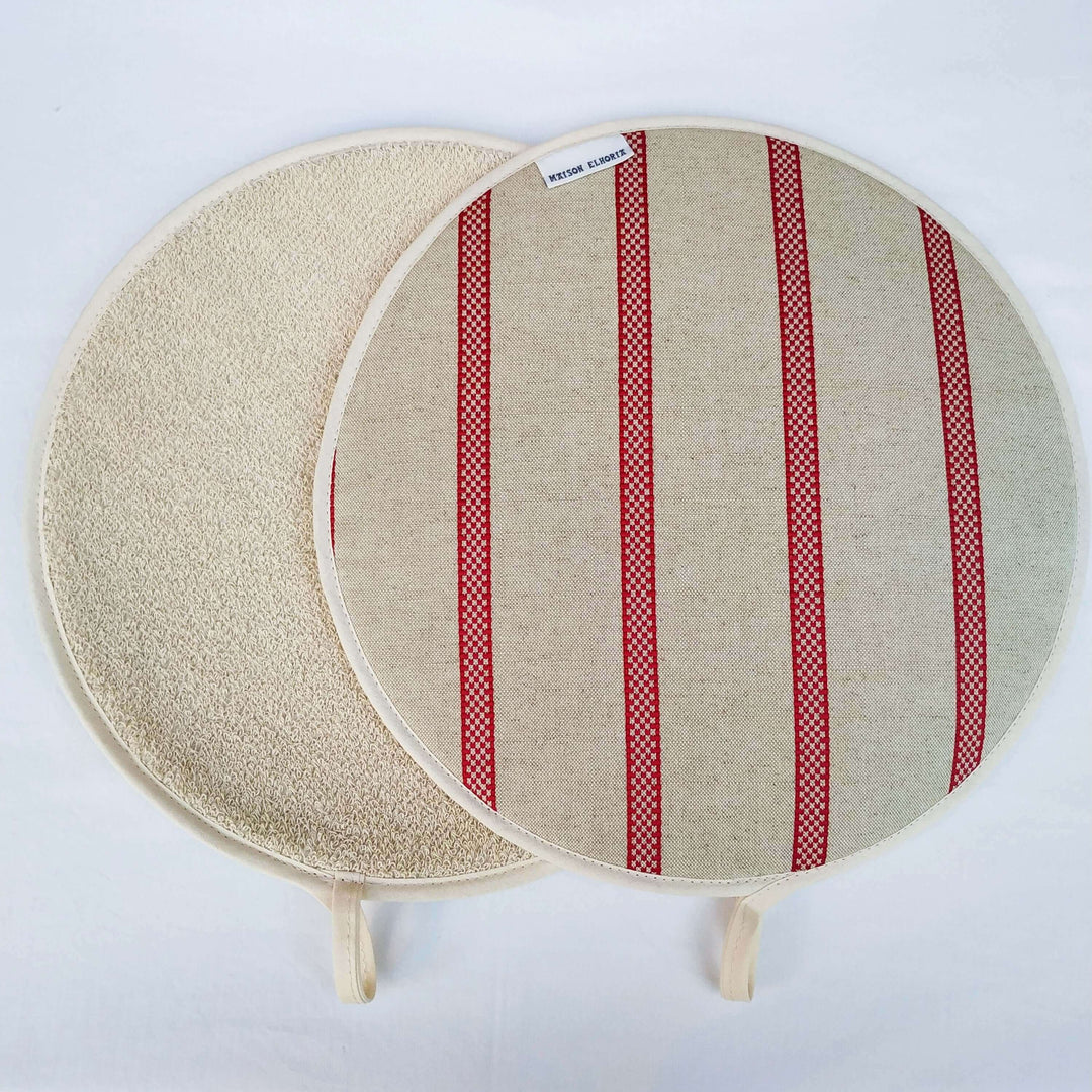 Two Linen union with Red stripes insulating Aga hob plate covers showing the front and back with beige heat resistant toweling, off white background