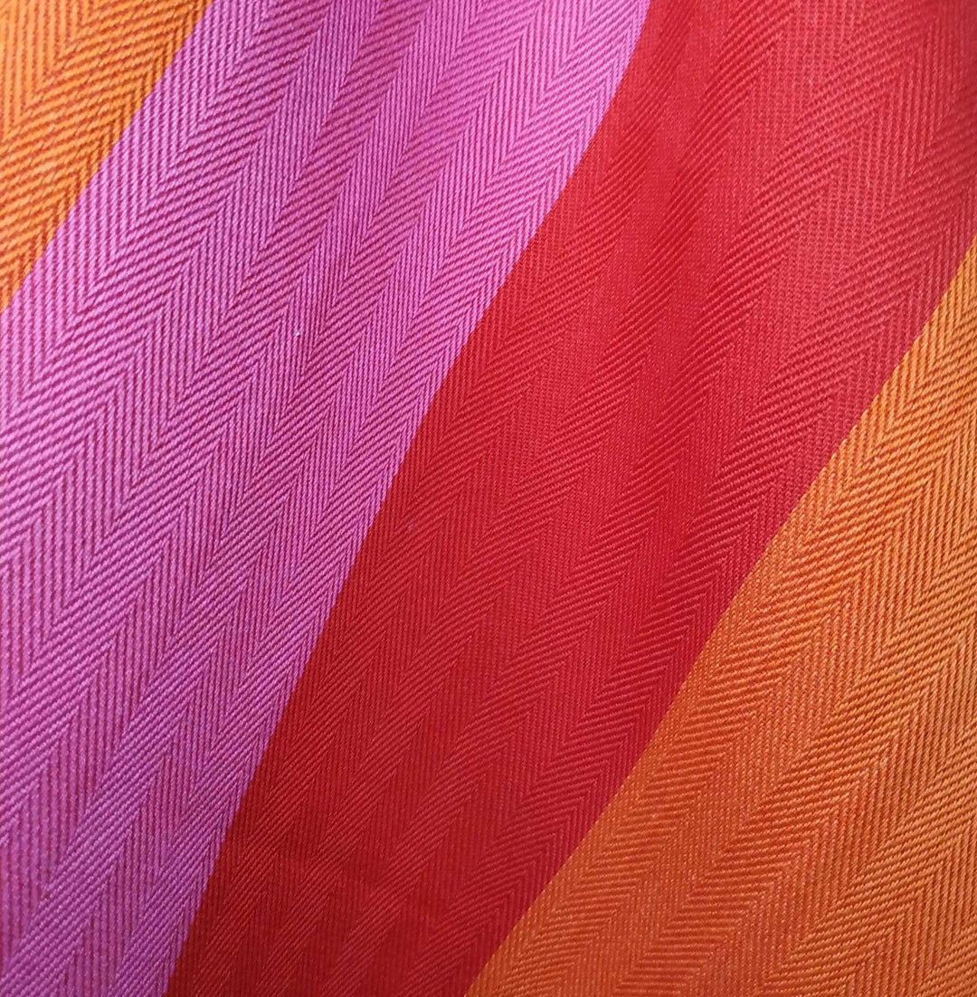 Red orange pink striped fabric close up