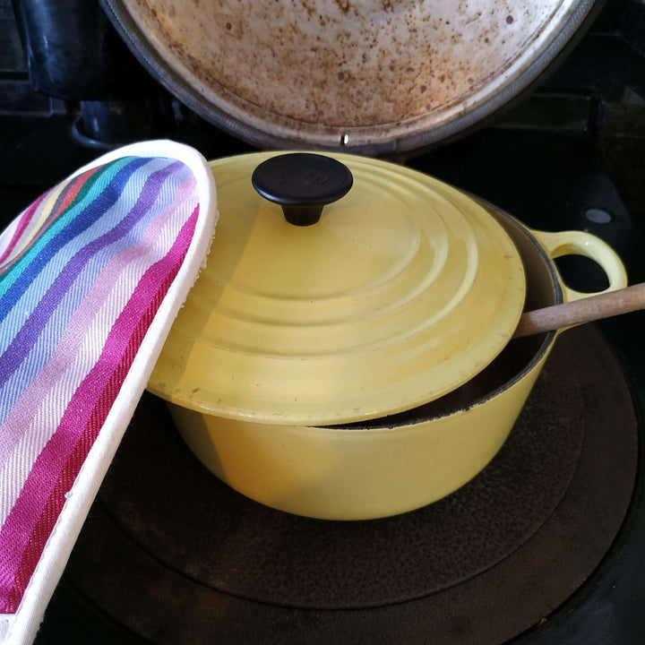 Premium linen union double oven gloves rainbow  on cast iron yellow pot on  an Aga cooking ring