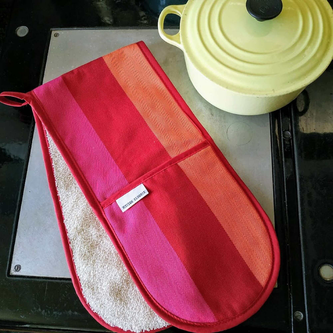 Aga double oven Mitt red orange pink with a yellow cast iron pot on an Aga hot plate