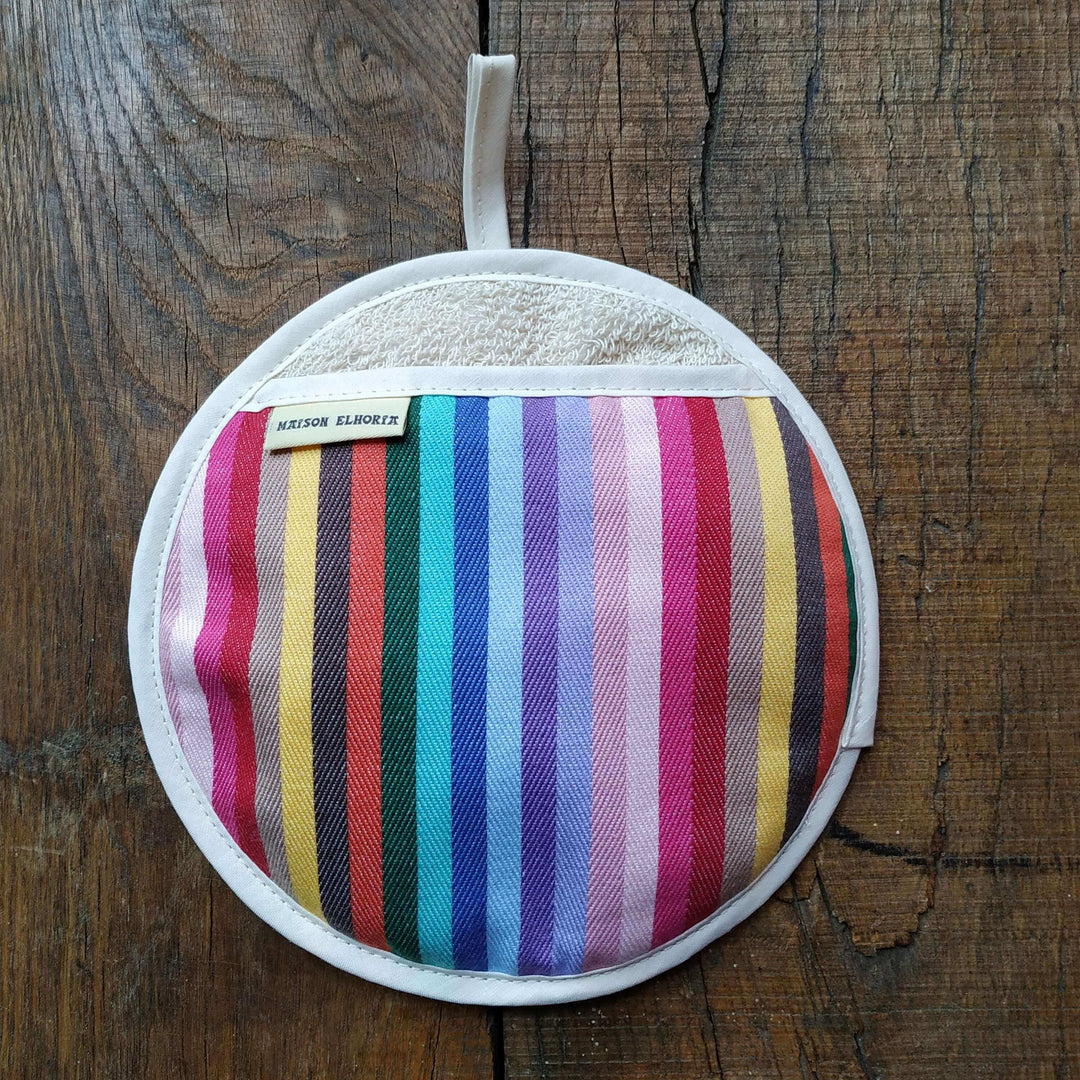 Rainbow round pot holder or pot  grabber type oven mitt on a wooden table background