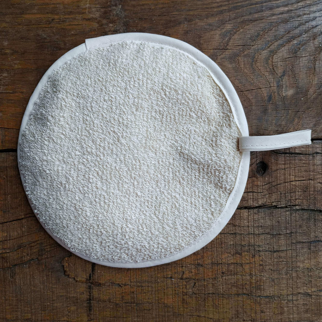 Heatproof holding side of a round pot grabber on a wooden table background