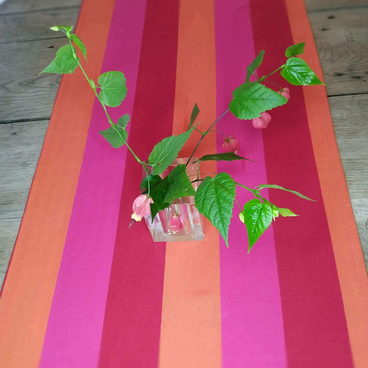table runner cotton heavy weight striped red orange pink with Christal vase  and green leaves and flowers