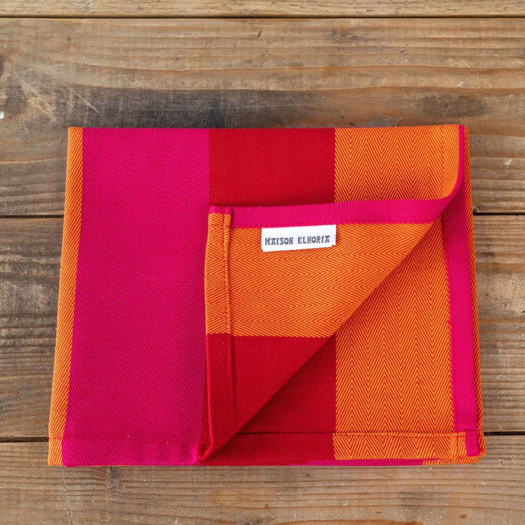 Organic and recycled cotton  sustainably made napkin folded on a wooden table