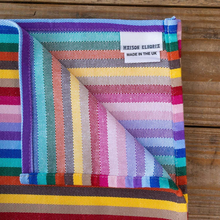 Rainbow napkin organic cotton close up on wodden table 