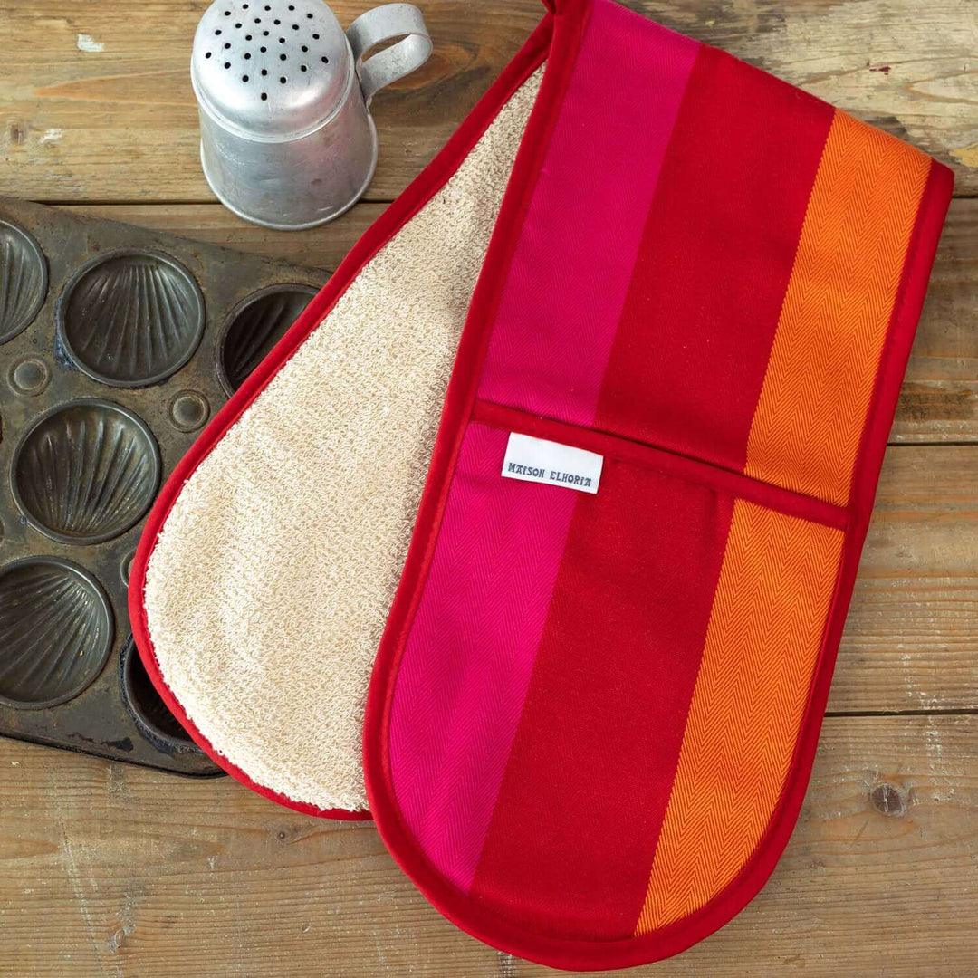 Premium double oven mitts red orange pink   on wooden table with baking accessories