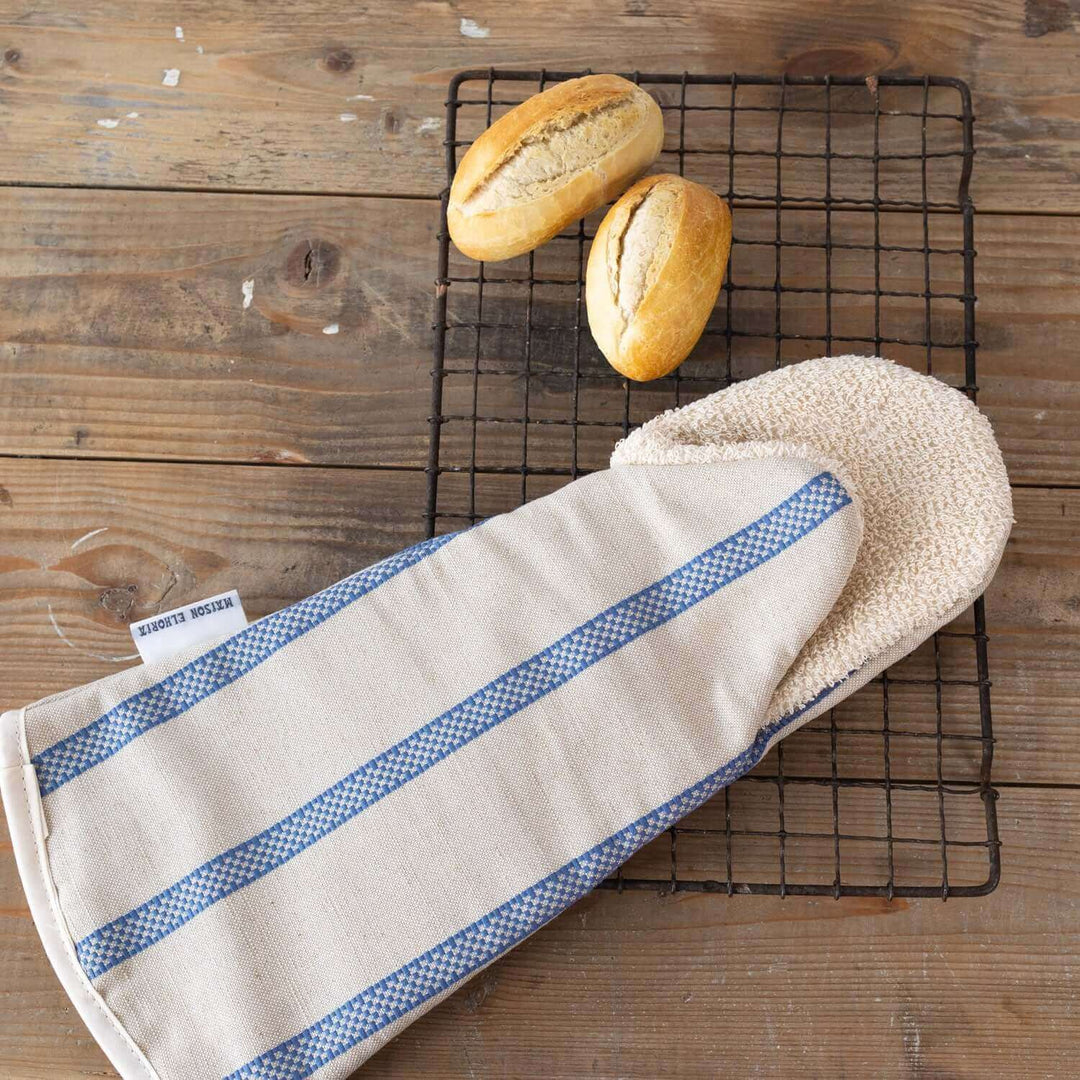 Snapper Gauntlet long oven glove  linen union with blue stripes with breads on a wooden table