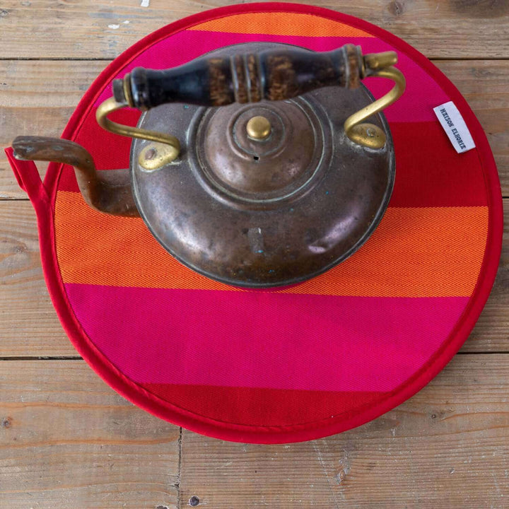 Red Orange pink striped premium quality insulating Aga hob plate cover on wooden surface with antique kettle on top from Maison Elhoria